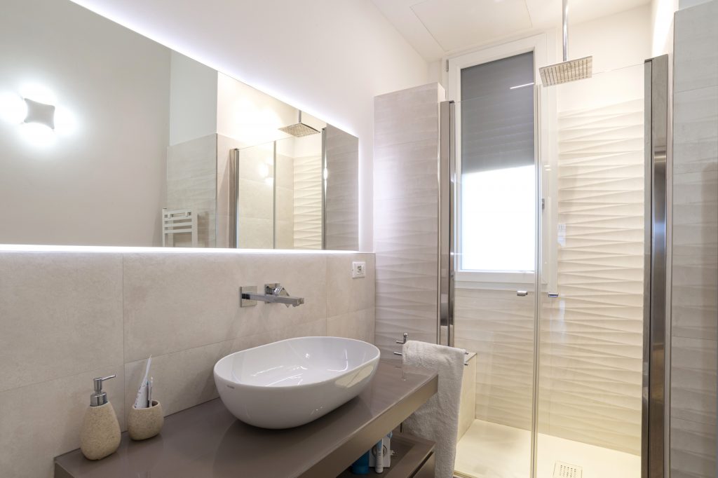 Bagno in stile moderno con lavabo d'appoggio bianco.