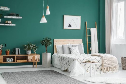 Camera da letto tile moderno con parete verde e mobili design