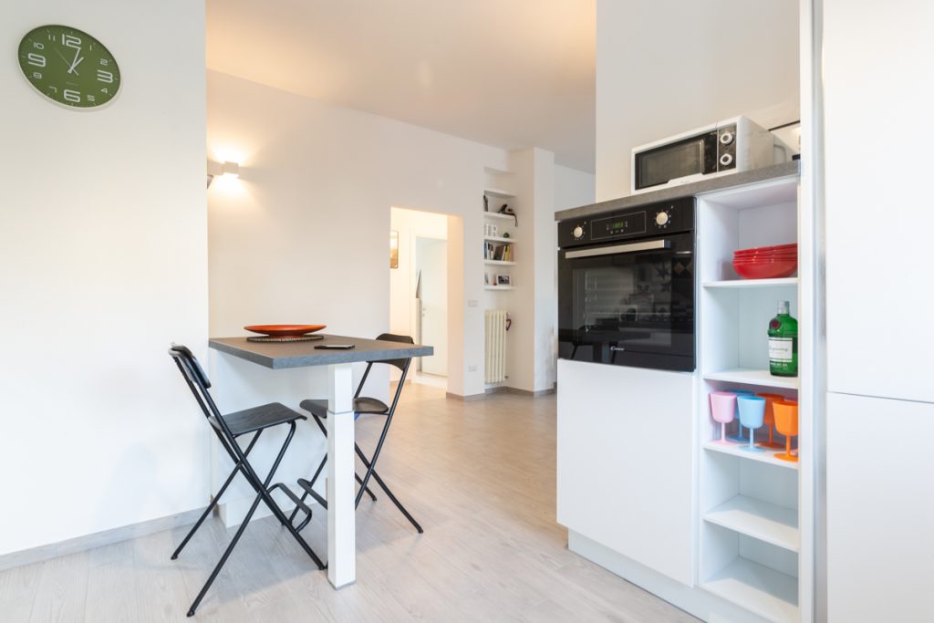 Ristrutturazione casa Lecce open space con cucina bianca e nera con penisola.