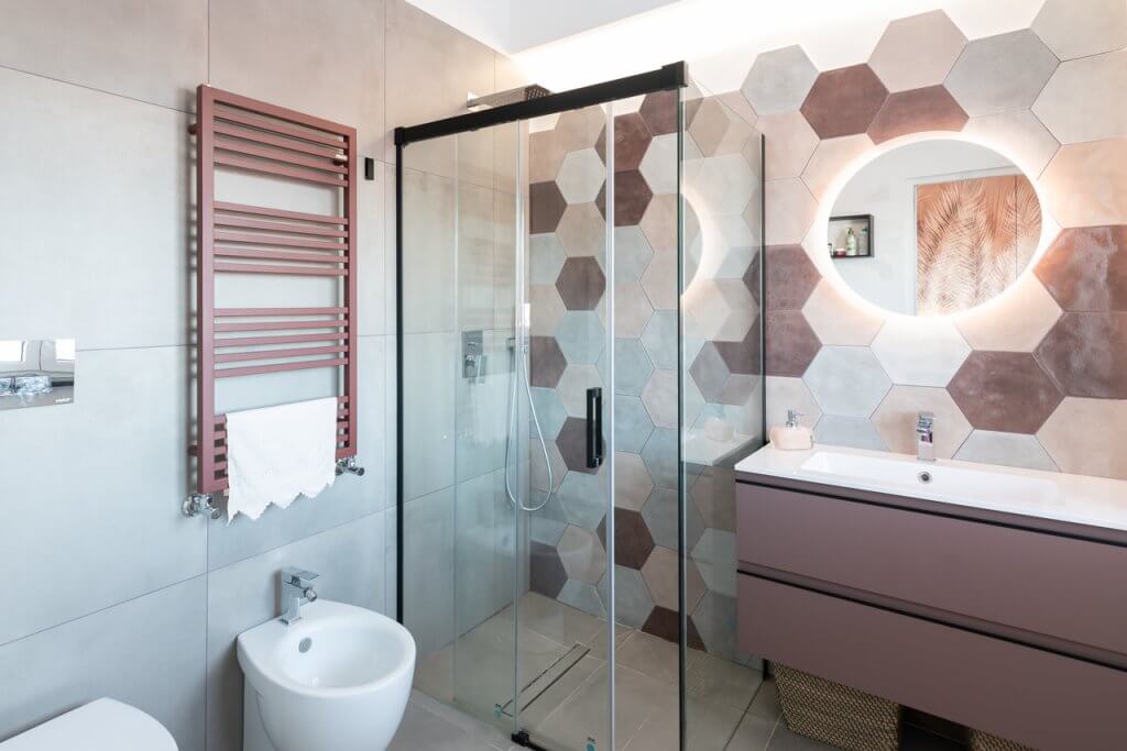 Bagno con mattonelle geometriche e box doccia